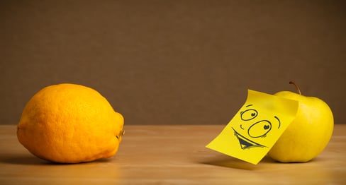 Apple with sticky post-it note reacting at lemon