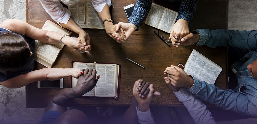 Group holding hands during bible study