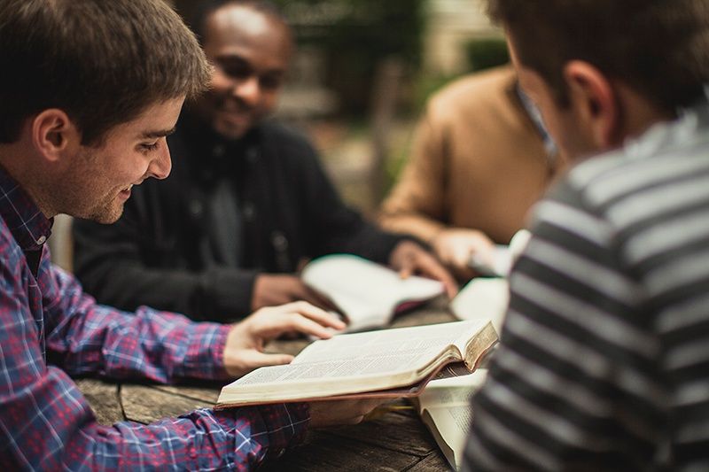 Group of church stewards reading the Bible