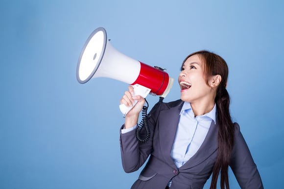 Image of Businesswoman making announcement with megaphone
