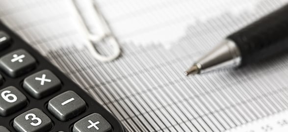Calculator, Pen on Top of Church Finance Report