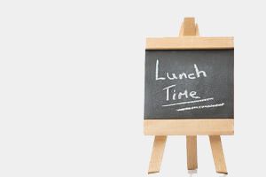 Chalkboard with the words lunch time written on it isolated against a white background-2-1