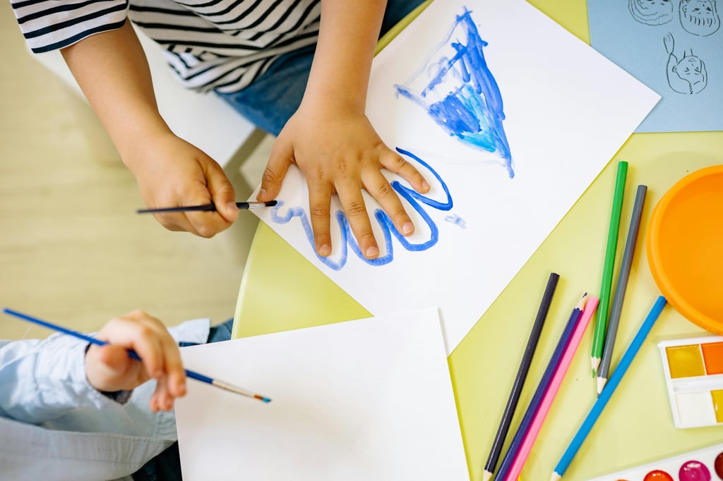 Child doing a painting sensory activity for preschoolers
