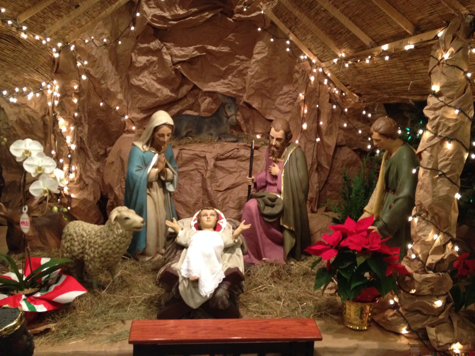 Christmas image of a Nativity scene with Christmas lights around it