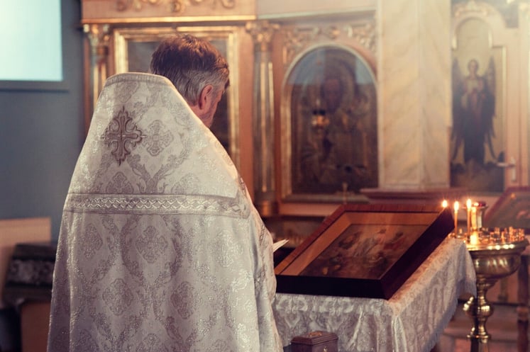 Church Leader Standing at Pulpit Wearing Robe