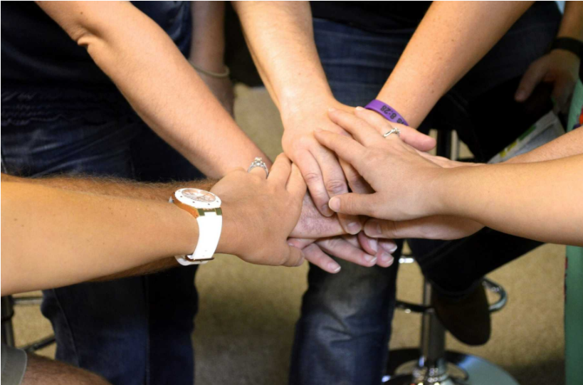 Church Retreat Survey Questions Blog - Hands in a huddle