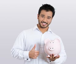 Closeup portrait of young smiling student, worker man holding piggy bank, giving thumbs up, isolated on white background. Smart currency financial investment decisions. Budget management and savings