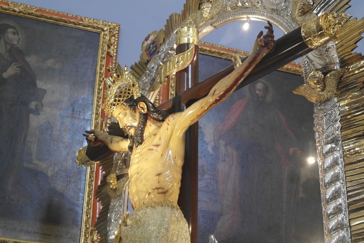 Crucifix of Jesus Looking Down on Church Members