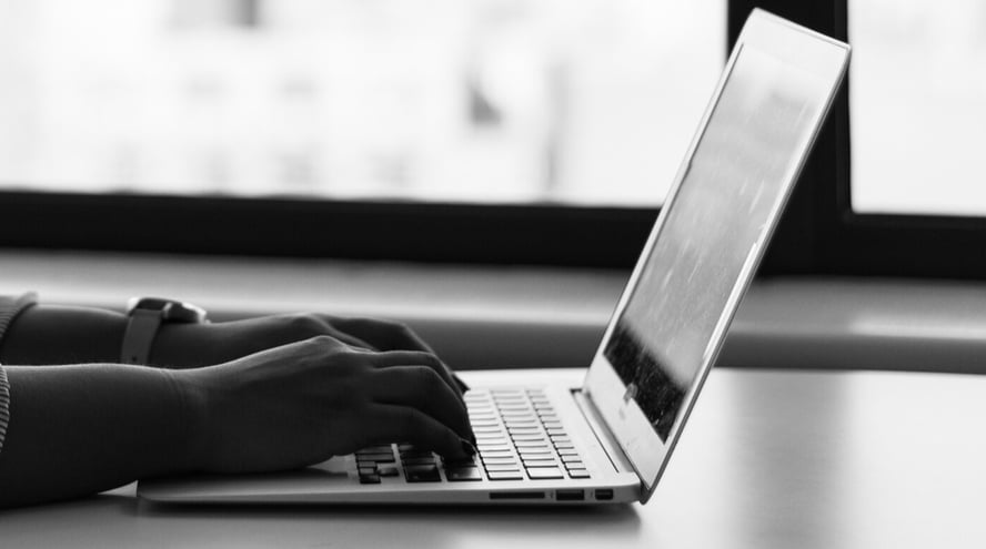 Daycare Provider Using Billing Software on Laptop