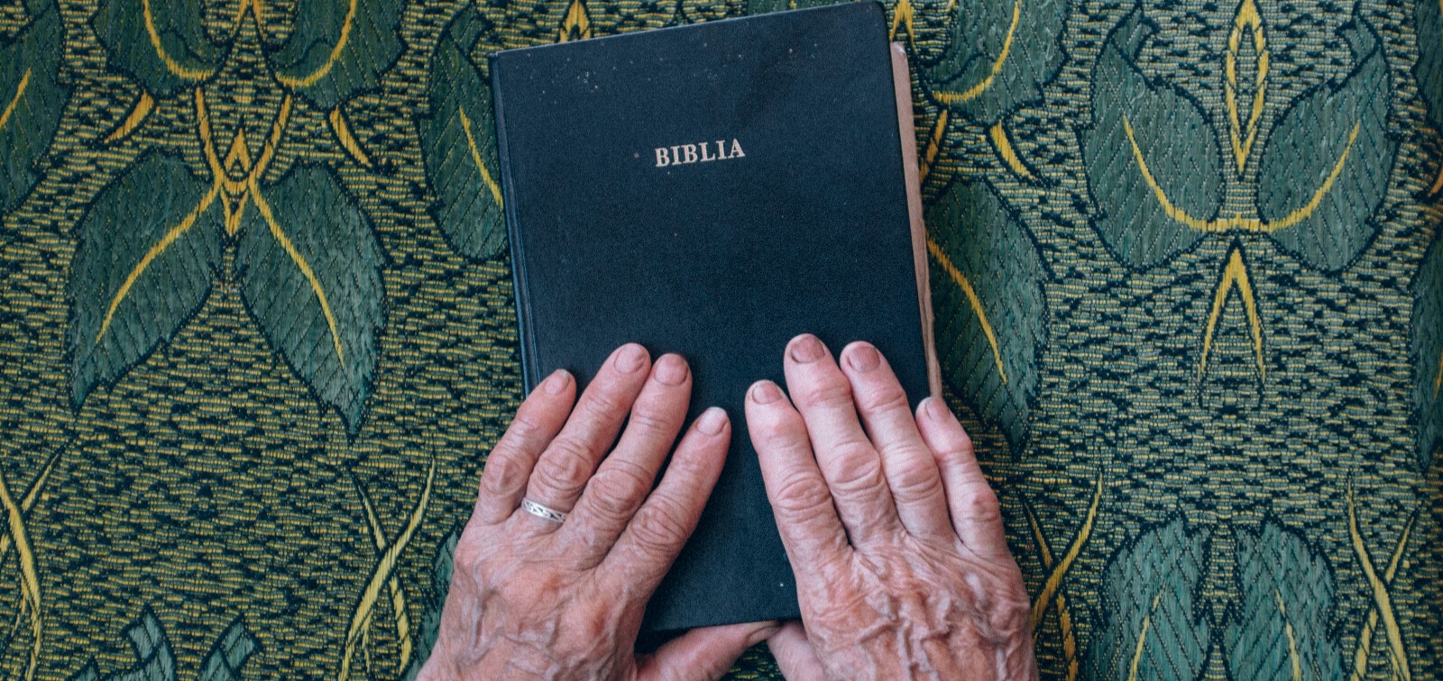 Elderly Hands on Bible