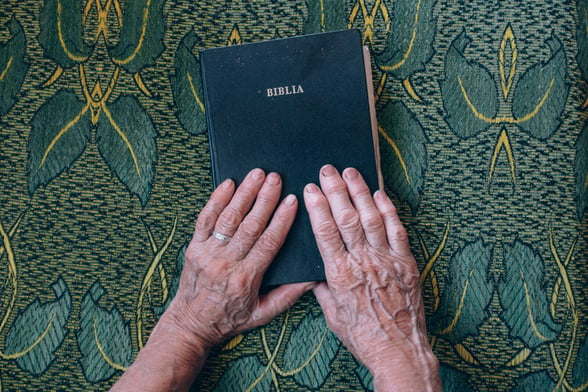 Elderly Hands on Bible