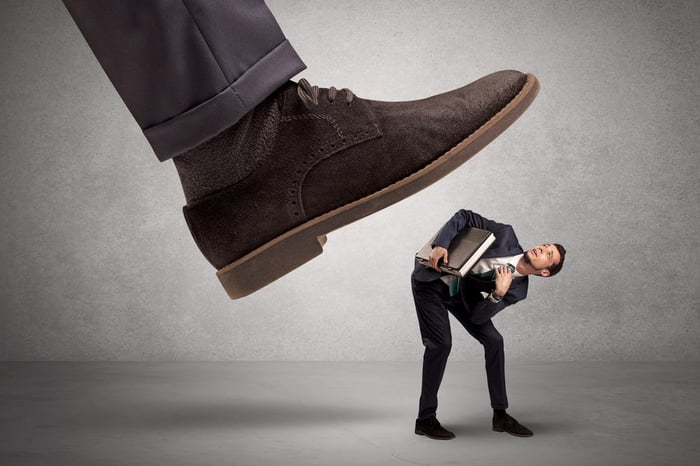 Church Bully Stepping on Man in Suit