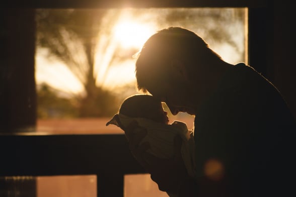 Fathers Day image of a father and newborn baby