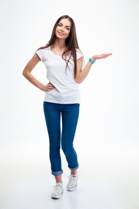 Full length portrait of a smiling woman holding copyspace on the palm isolated on a white background. Looking at camera