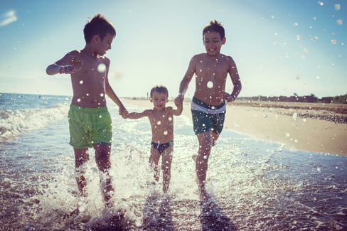 Fun kids playing splash at beach