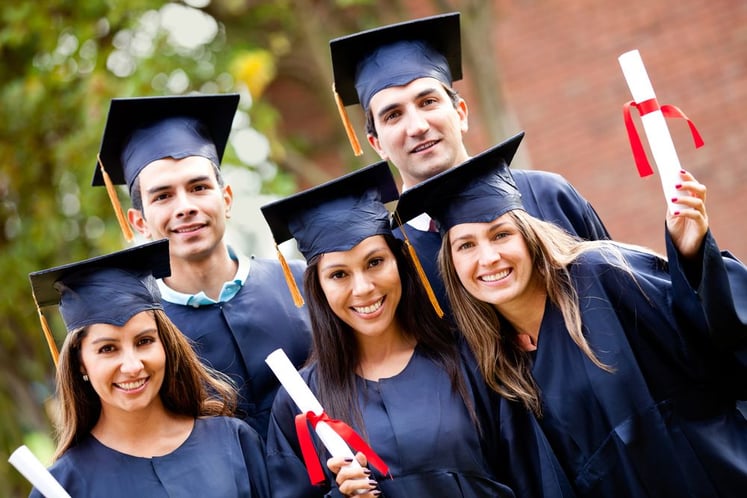 Group of graduate students holding their diploma after graduation