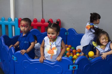 Preschoolers playing in ball pit during large group activity