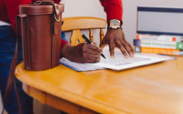 Photo of someone filling out a church membership form