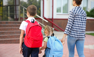 Teacher walking with two students