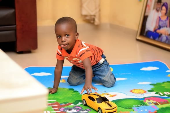 Little Boy at Preschool with a Toy Car