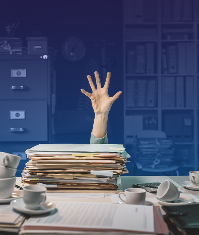 hand-raised-above-messy-desk