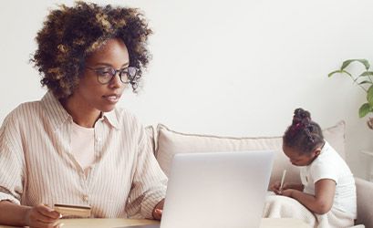 mother paying invoice on laptop