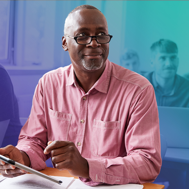 older-man-in-class-holding-iPad