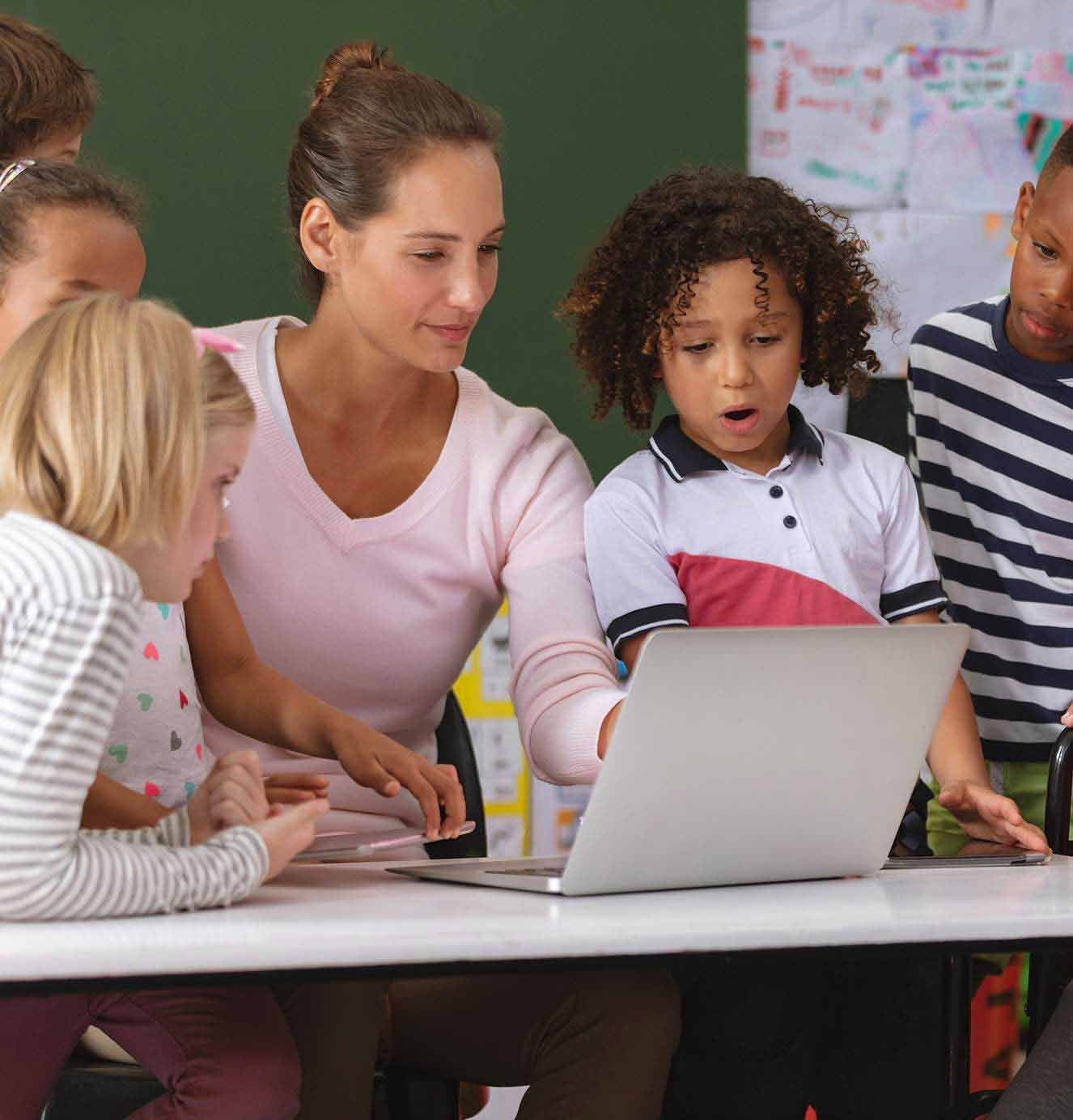 teacher-on-computer-with-students