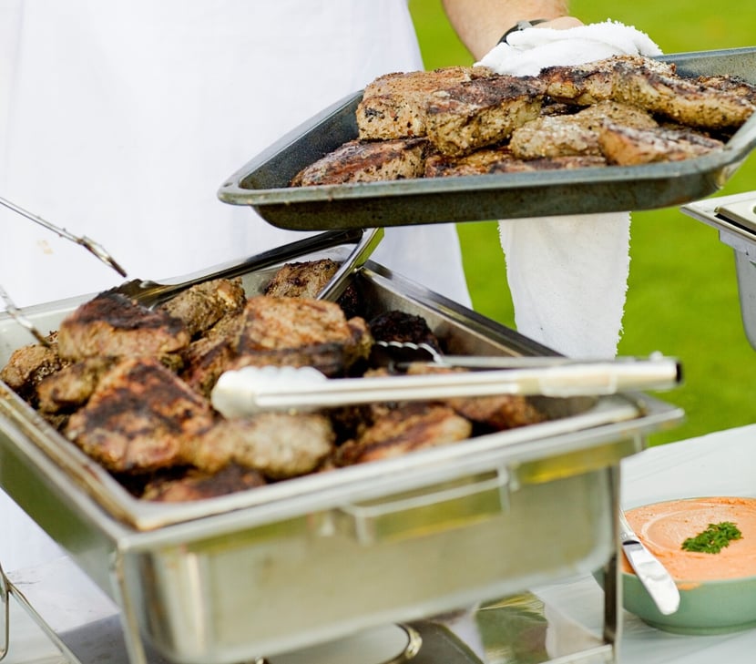 Man Cooking Meat at Homecoming Fundraiser