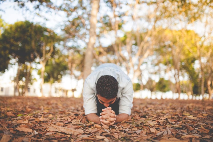 Man Giving a Closign Prayer on Leaves
