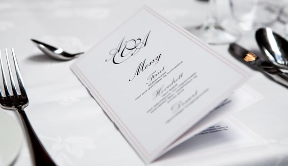 Menu on Table with silverware and tablecloth