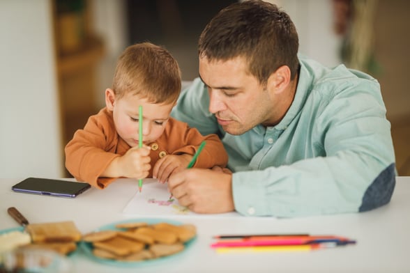 Parent and their preschooler working on homework together