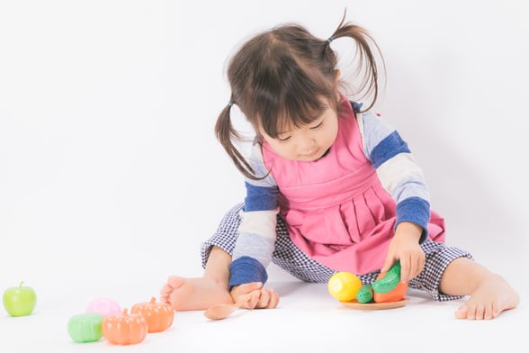 Preschool Girl Doing a Transition Activity with Plastic Toys