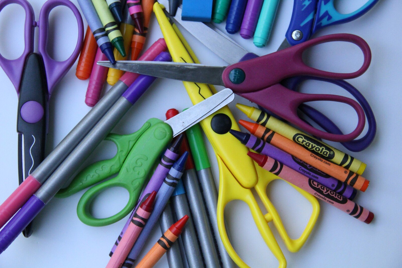 Image of preschool supplies, including scissors and crayons