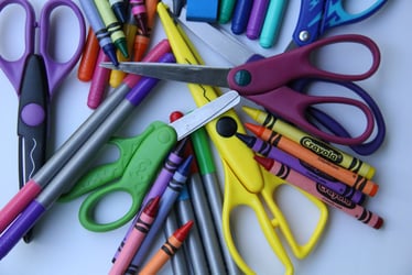 Image of preschool supplies, including scissors and crayons