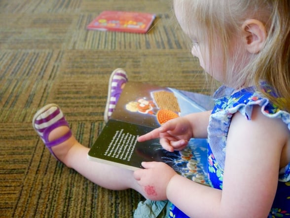 Preschool student reading a book