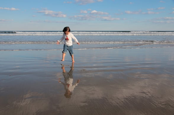 Preschooler at the beach playing in the water