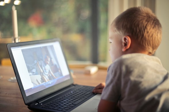 Preschooler watching video on laptop