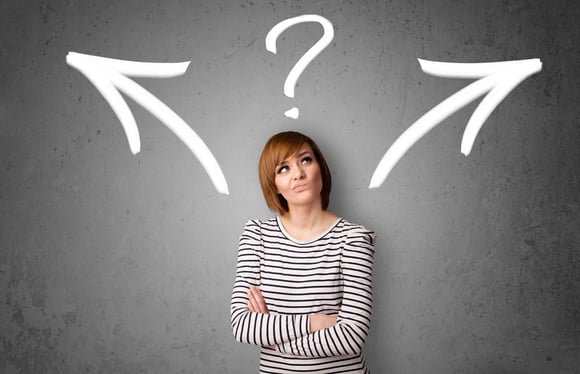 Image of Pretty young woman making a decision with arrows and question mark above her head