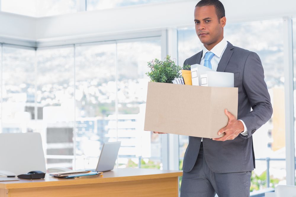 Member leaving the church, carrying a box.