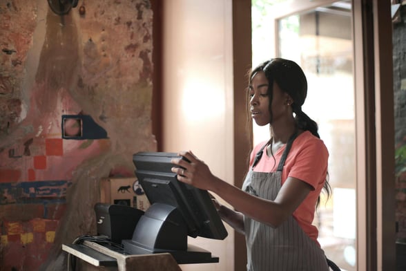 School lunch worker using a new school nutrition software on the POS system