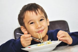 Kid eating spaghetti-COVID-19 School Lunch Post