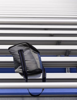 School Spirit Wear Fundraisers - bag on a bottom level of bleachers