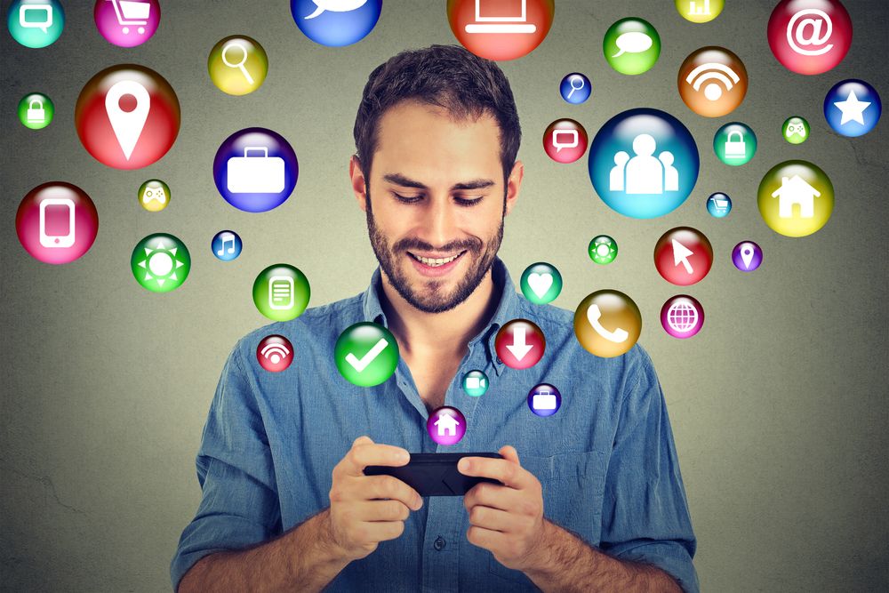 Church Social Media Strategy Blog - Guy with Phone & Icon Bubbles