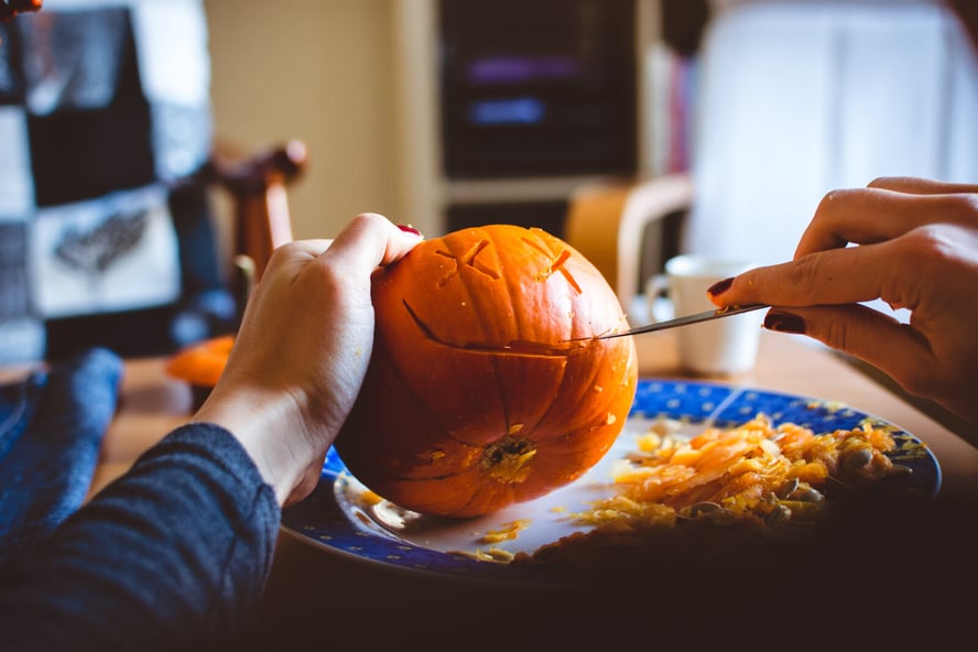 Student Carving a Pumpkin for a Fall Fundraiser