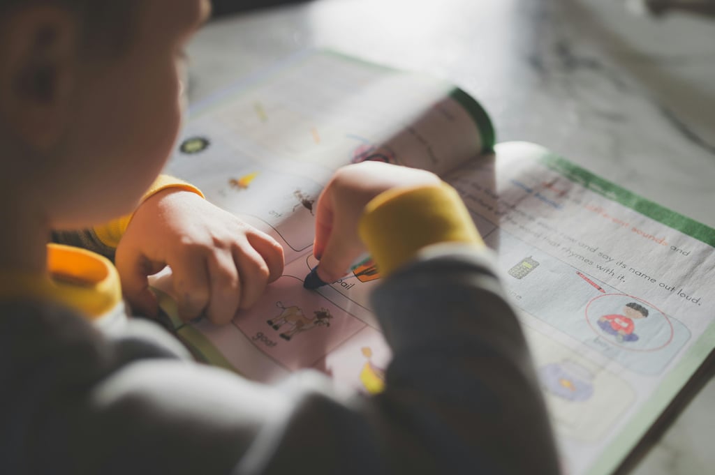 Student filling out a five senses worksheet for preschool