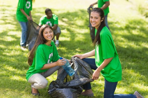 Team of young volunteers picking up litter in the park-1