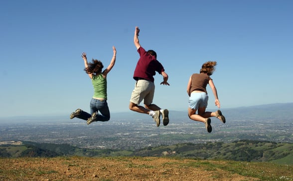Three church leaders jumping in the air, having fun at church retreat
