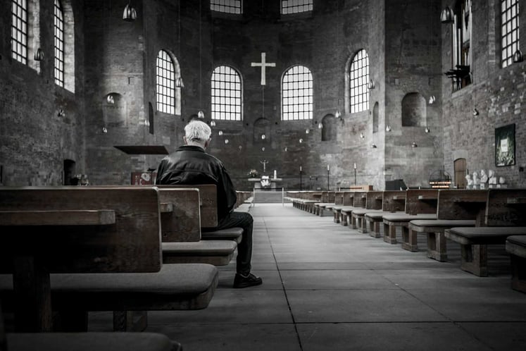 Toxic Church Member sitting in a church pew