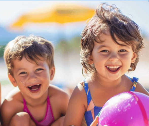 Two preschool kids at the beach in swim clothes